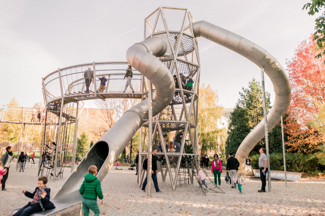 Busy playground with large metal slides